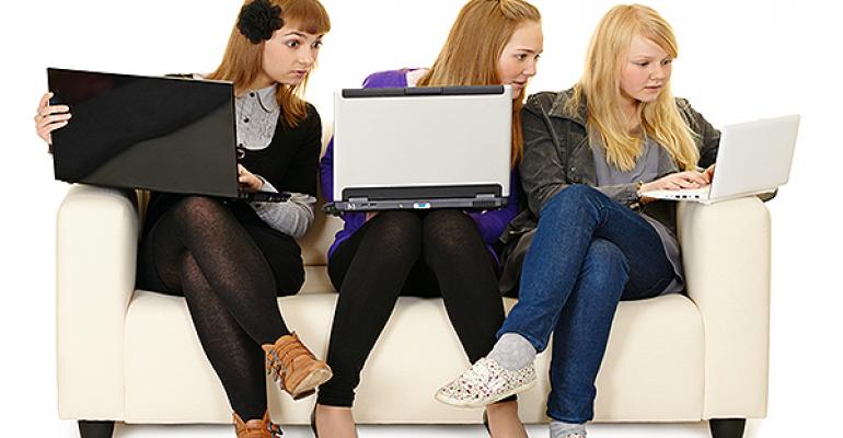 Girls looking at one anothers computers