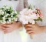 two brides with bouquets